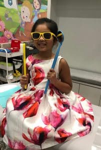Child with giant toothbrush at Stonebrook Pediatric Dentistry