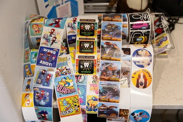 Rolls of colorful kids' stickers, including "I was brave!" stickers